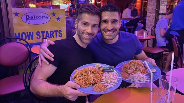 Stef and Seby enjoying a pad Thai at the Balcony gay restaurant in Bangkok.