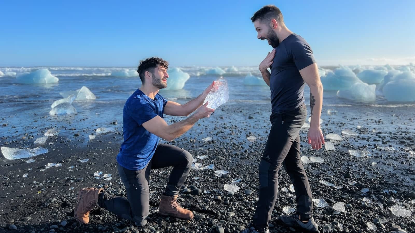 Gay couple at the Diamond Beach in Iceland making a romantic proposal.