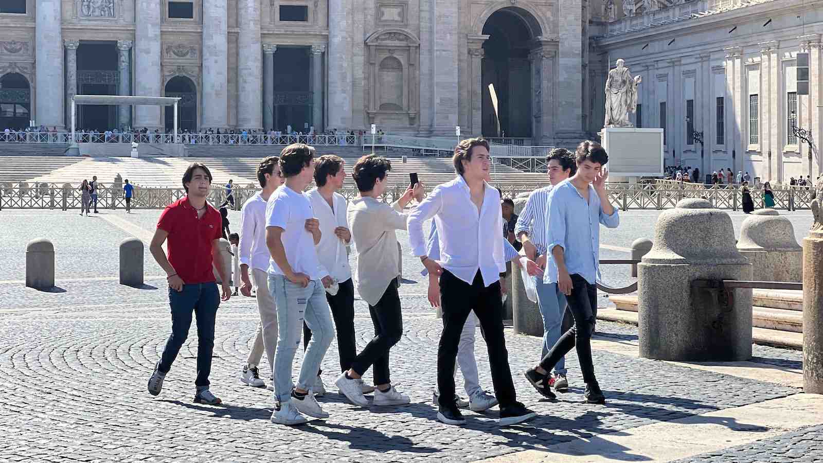 A group of young men walking past the Vatican in Rome.