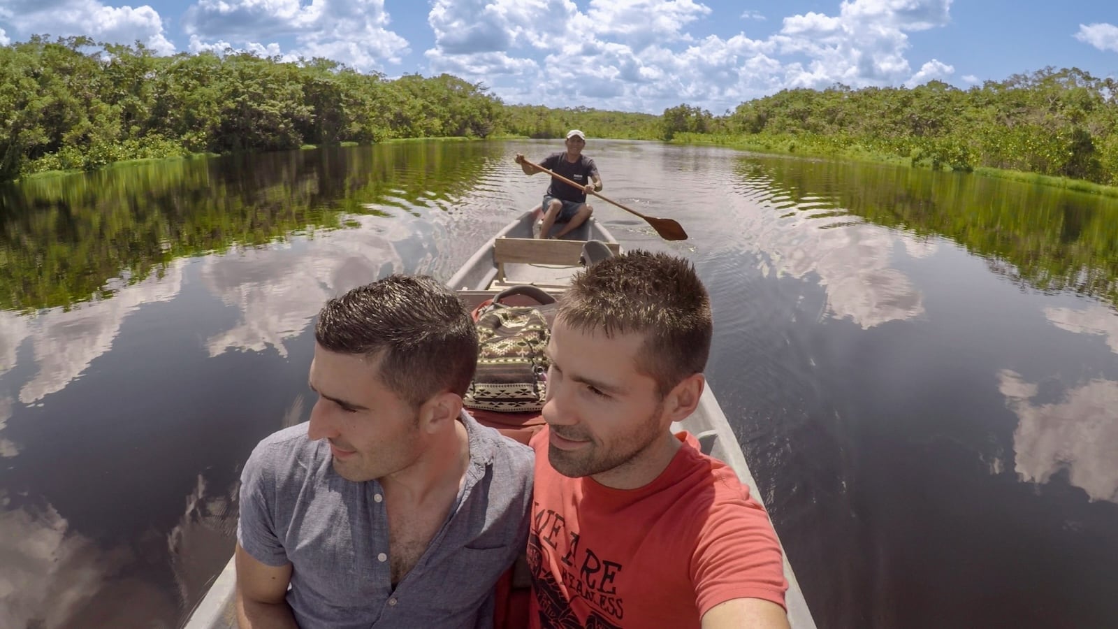 Gay couple on a boat in Amazon river in Ecuador.