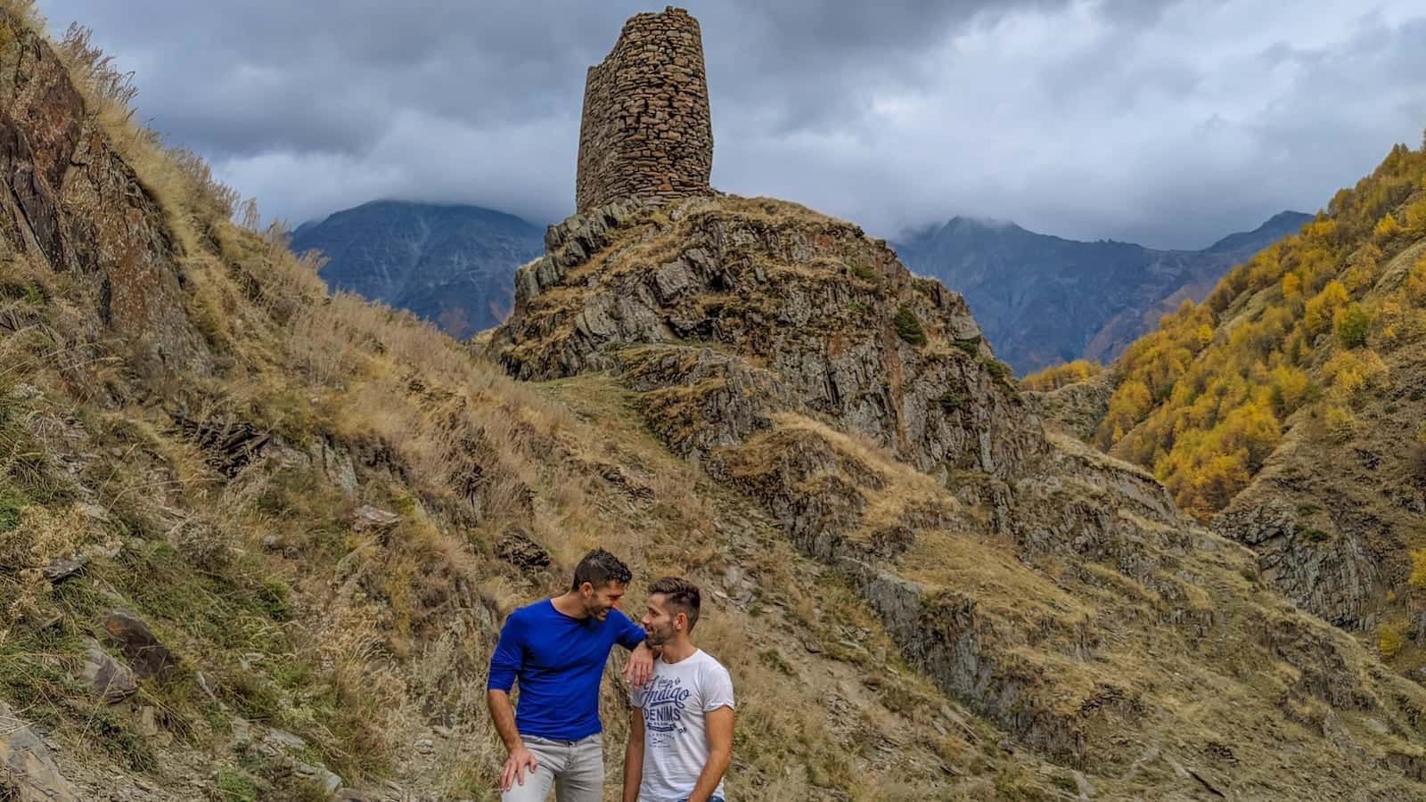 Gay couple hiking in the Kazbegi mountains in Georgia.