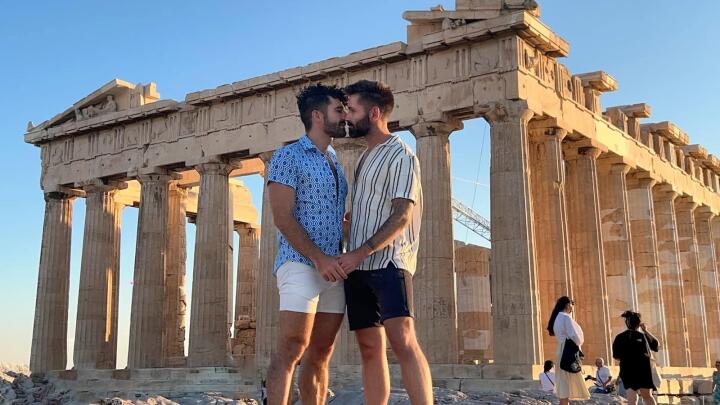 Gay couple kissing at Acropolis in Athens.