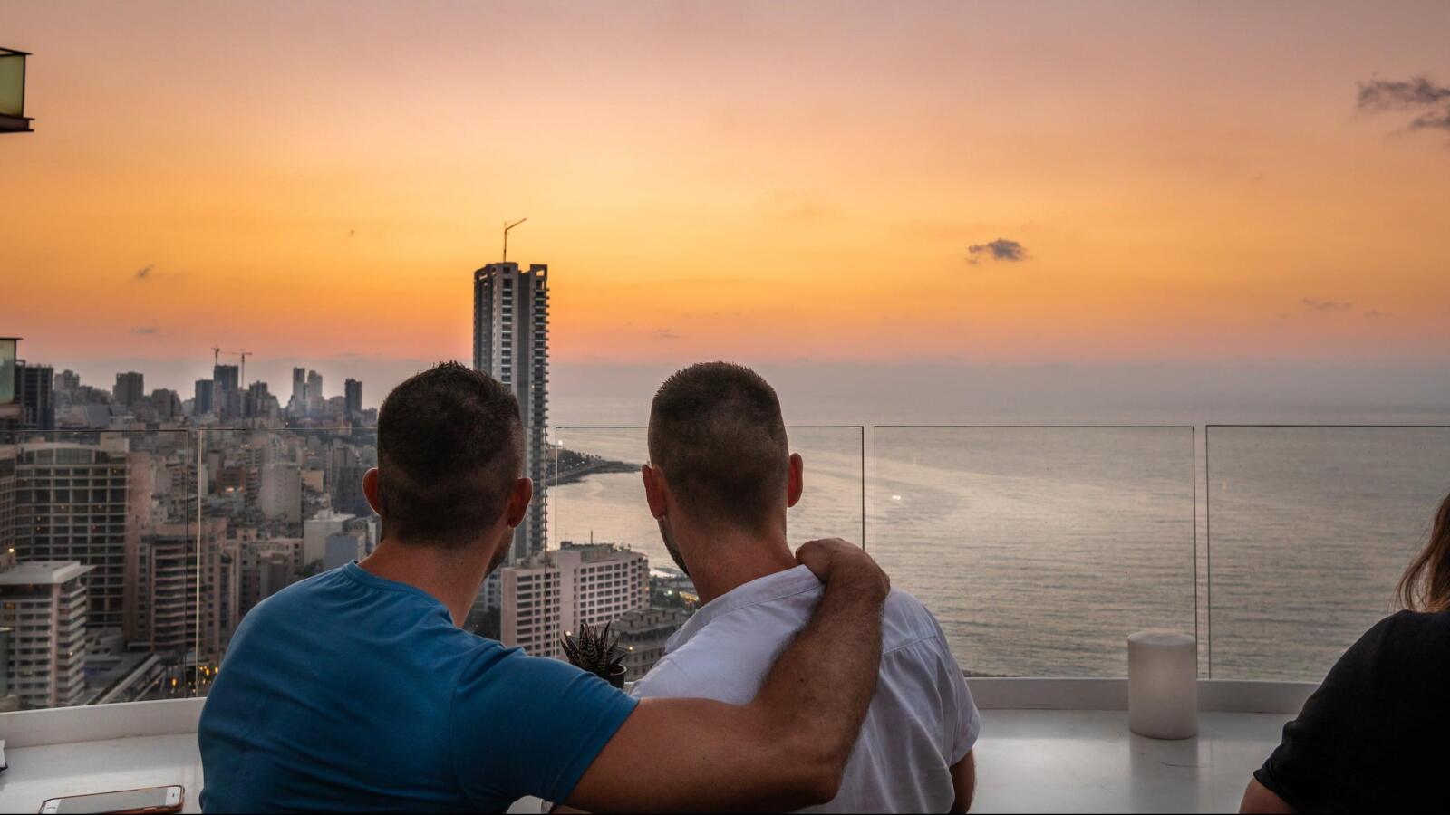 Gay couple with view of downtown Beirut.