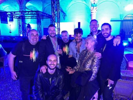 Stefan and a group of LGBTQ Italian friends posing at Milan Pride.