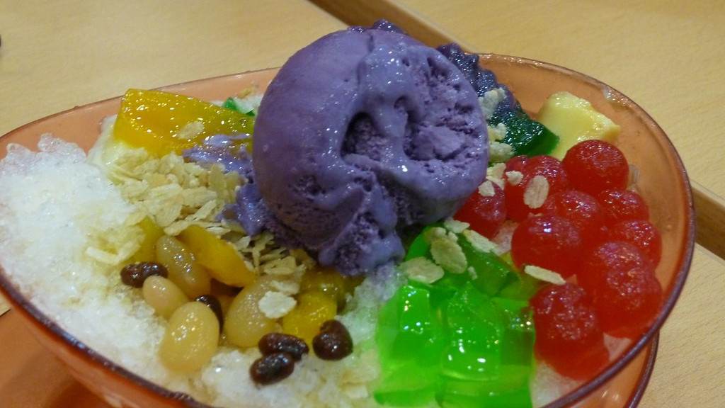 Halo Halo Filipino desert presented in a transparent dish with ice creams and beans