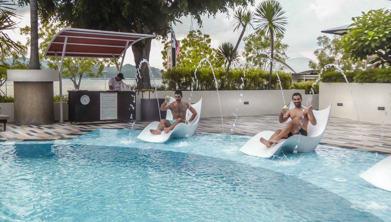 Nomadic Boys chilling by the pool of the gay friendly hotel Gyatt regency in Kota Kinabalu