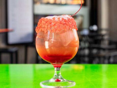 Close up of a fancy orange cocktail at the Il Borgo Delle Perse gay club in Milan.