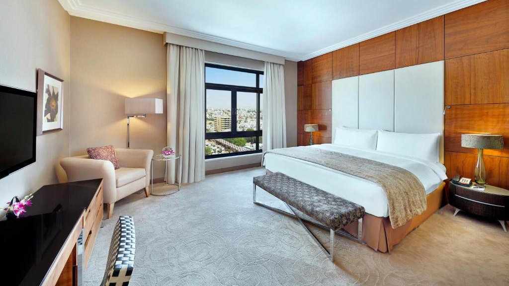 A large bedroom with views over the city at the InterContinental Jordan hotel in Amman.