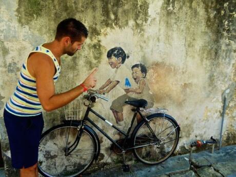 Sebastien had fun pretending to tell of these kids at one of our favourites of Penang's street murals