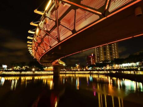 The Love River in Kaohsiung Taiwan is lit up at night and looks very romantic