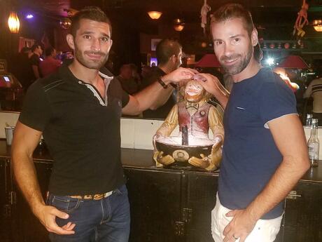 Nomadic Boys touching the monkey at gay bat Monkey bar in Key West