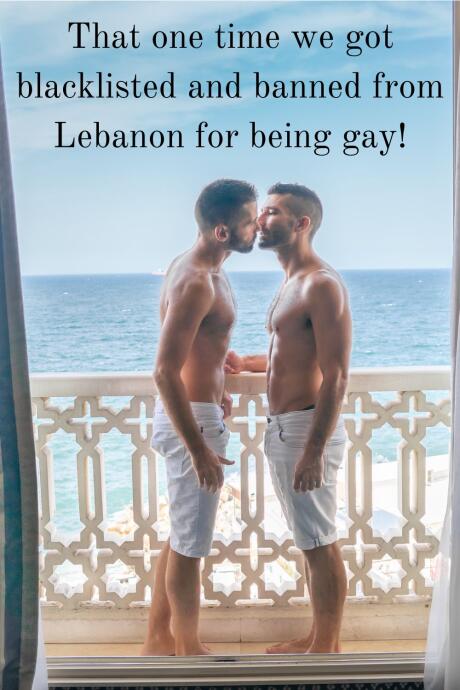 Gay couple embracing at hotel window in downtown Beirut.