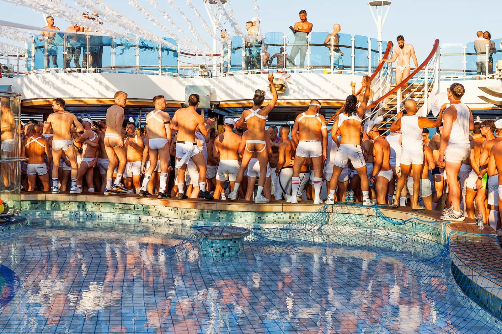 Guys partying by the pool on the La Demence gay cruise.