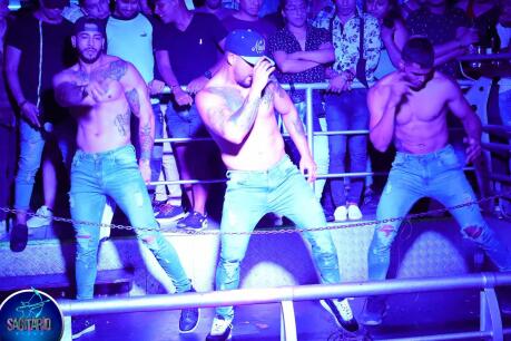 Topless men dancing at Sagitario club in Lima.