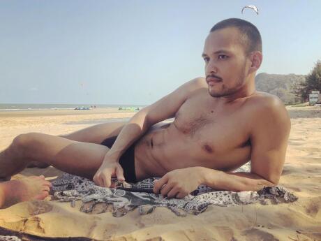 Handsome Thai guy on the beach in Phuket