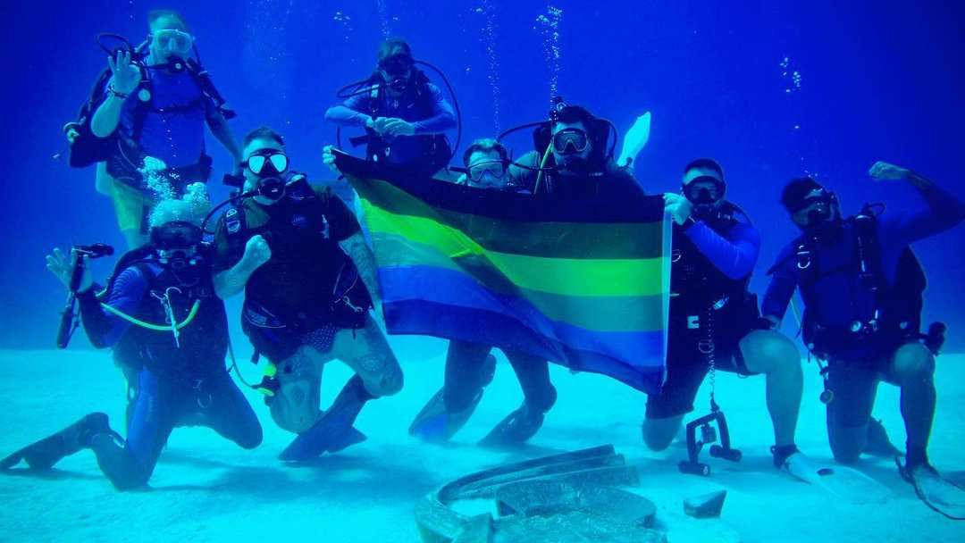 "Flying" the pride flag in the Sea of Cortez during a gay diving trip