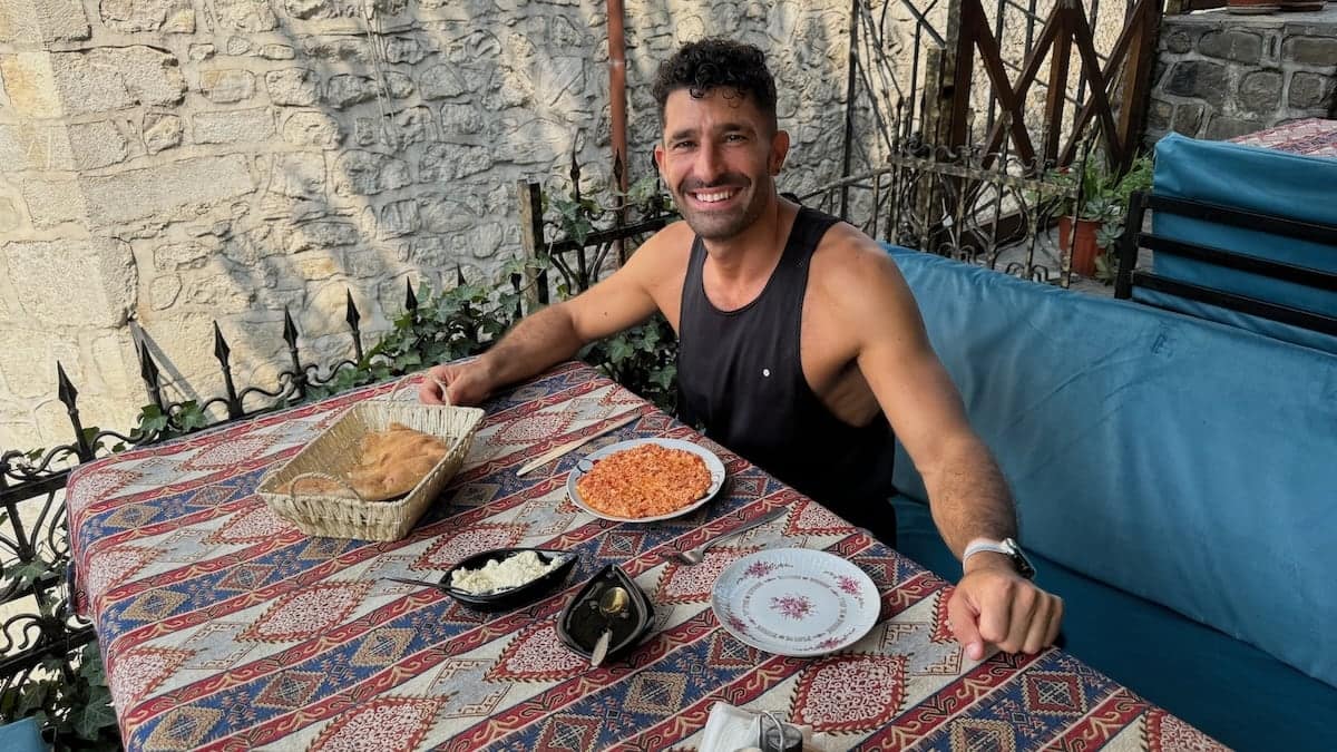 Stefan enjoying Azeri food including pomidor yumurta, gaimag and tendir.