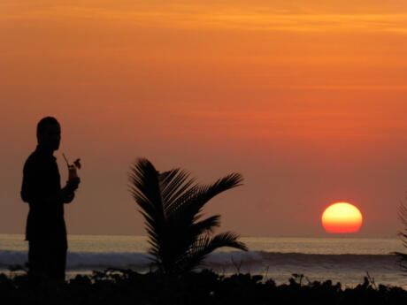 Gay travel to Bali - the sunsets in Bali are incredible, grab a cocktail and watch it with your partner on the beach