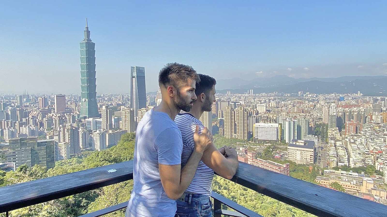 Gay couple enjoying the skyline of Taipei.