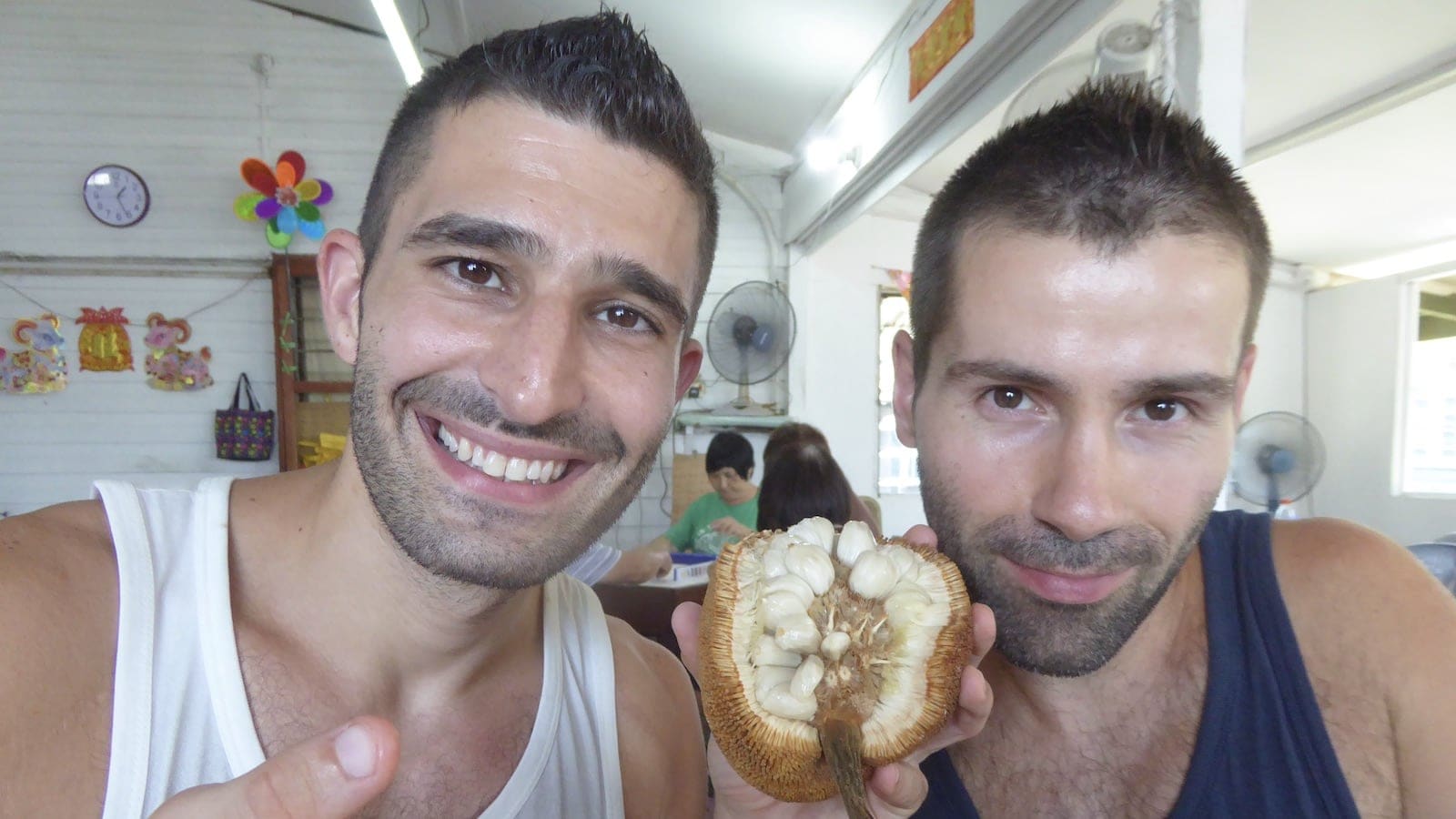 Gay couple trying the tarap fruit in Borneo Malaysia