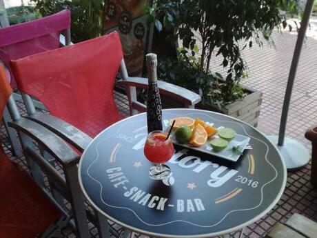 A table with drinks and fresh fruit at Victory Cafe in Athens